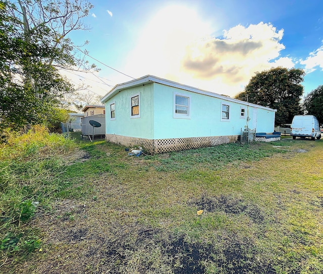 view of side of home featuring a yard