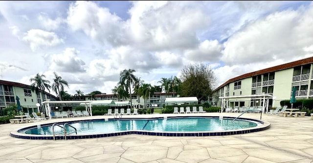 view of swimming pool featuring a pergola and a patio