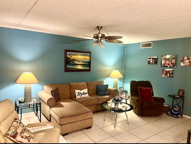 tiled living room featuring ceiling fan and a textured ceiling