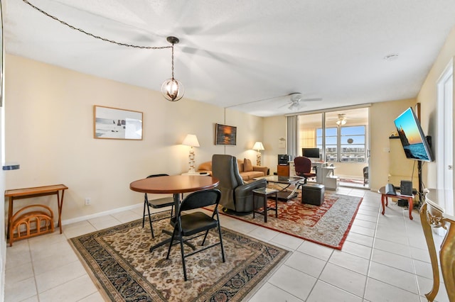 living room featuring light tile patterned floors and ceiling fan with notable chandelier