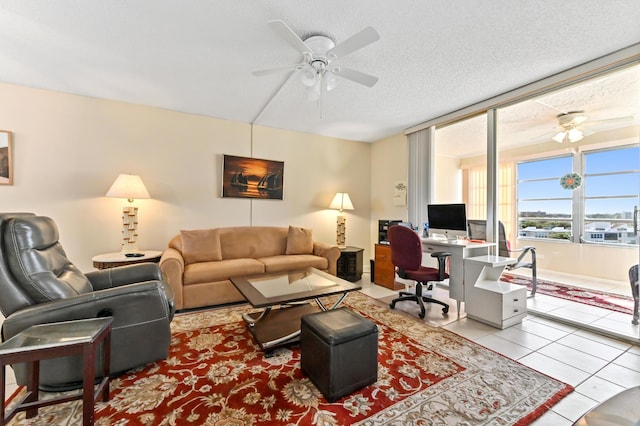 living room with light tile patterned floors, a textured ceiling, and ceiling fan