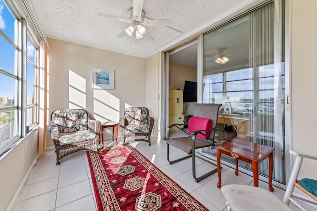 sunroom featuring ceiling fan