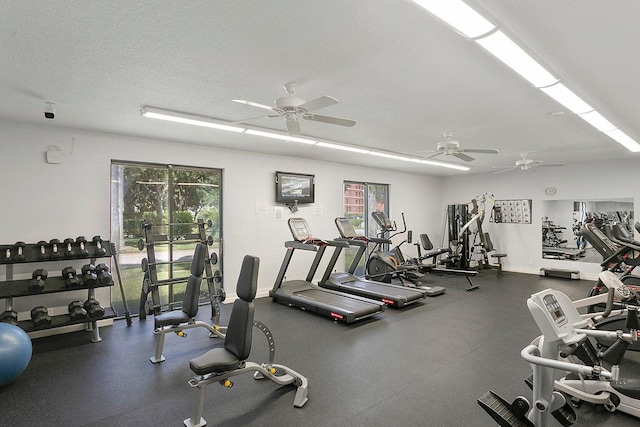 gym with ceiling fan and a textured ceiling