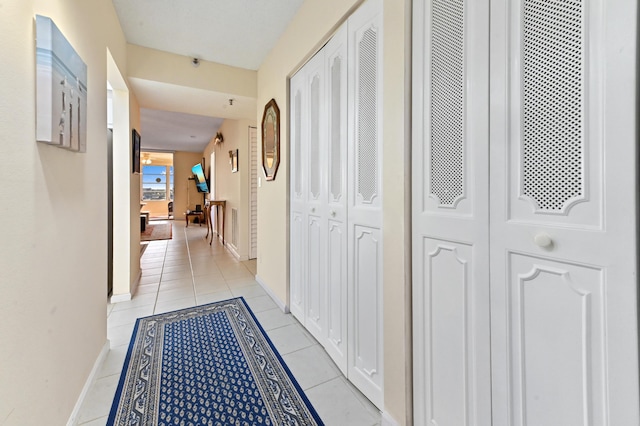 hall featuring light tile patterned floors