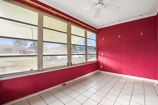 unfurnished room with light tile patterned floors, ceiling fan, and a healthy amount of sunlight