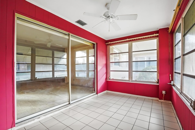 unfurnished sunroom with ceiling fan