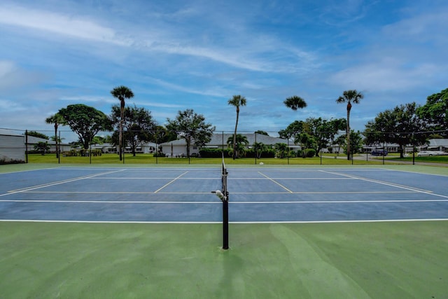 view of tennis court with basketball hoop