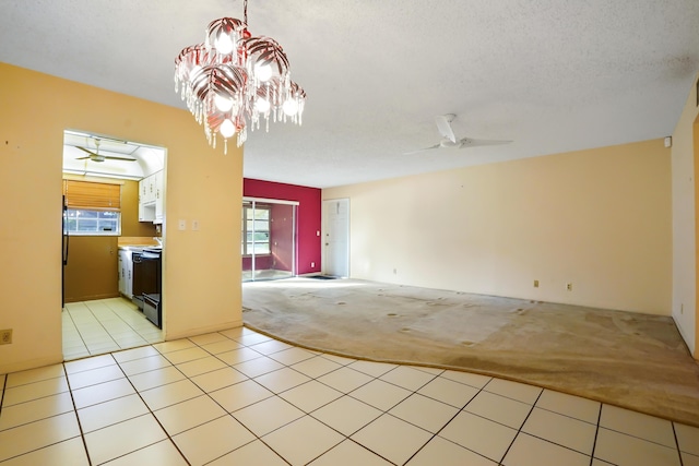 carpeted empty room featuring a textured ceiling and ceiling fan