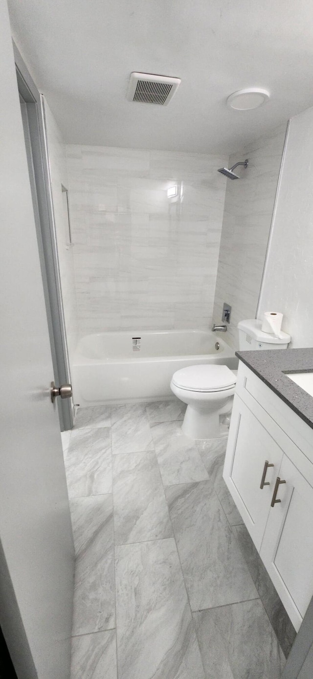 full bathroom with vanity, toilet, and tiled shower / bath