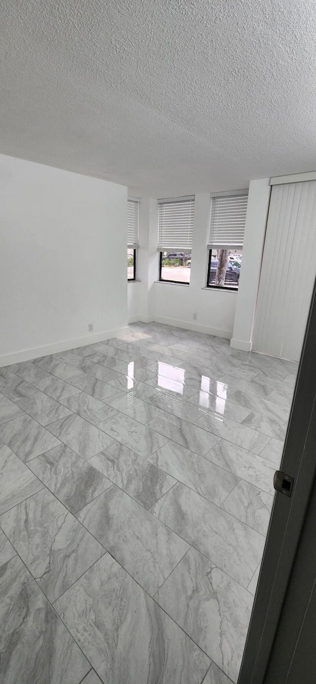 spare room with a textured ceiling