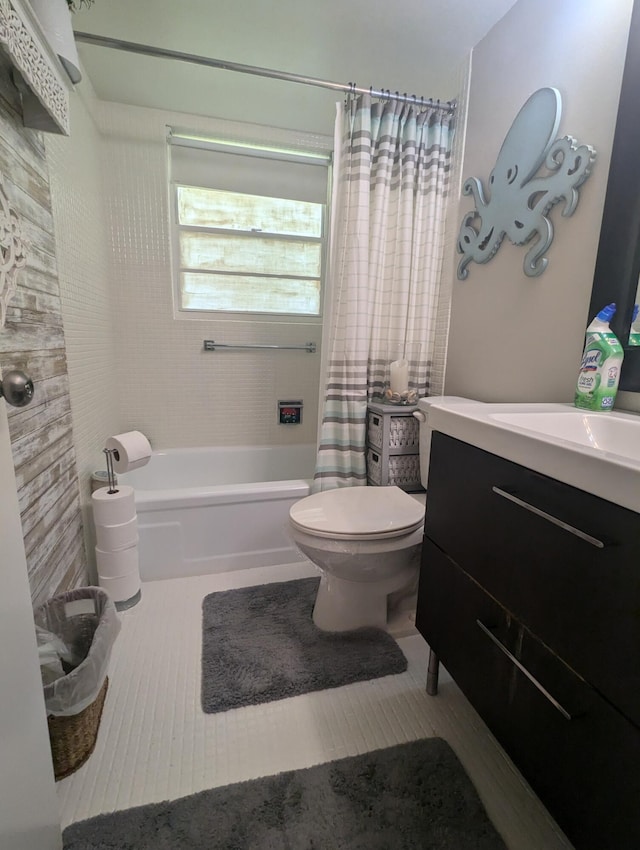 full bathroom featuring shower / bath combination with curtain, vanity, toilet, and tile patterned floors