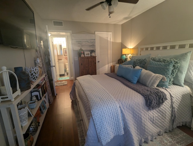 bedroom featuring hardwood / wood-style flooring, ceiling fan, a closet, and ensuite bath