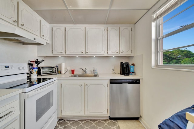 kitchen featuring stainless steel dishwasher, a drop ceiling, white range with electric stovetop, sink, and white cabinets