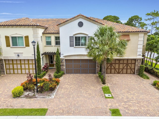 mediterranean / spanish-style home with a garage