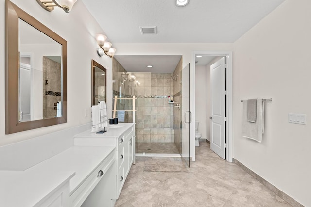 bathroom with vanity, toilet, and walk in shower