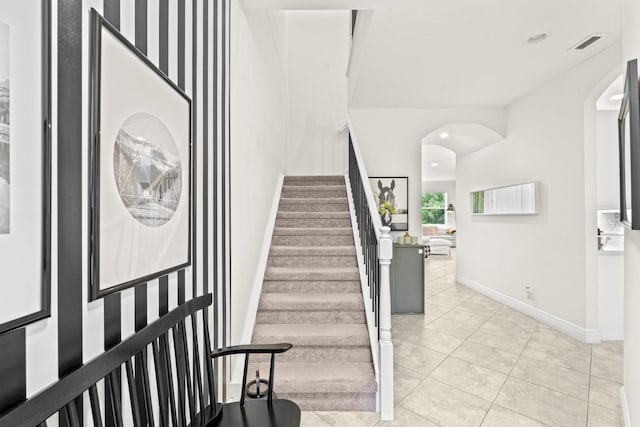 stairway with tile patterned floors