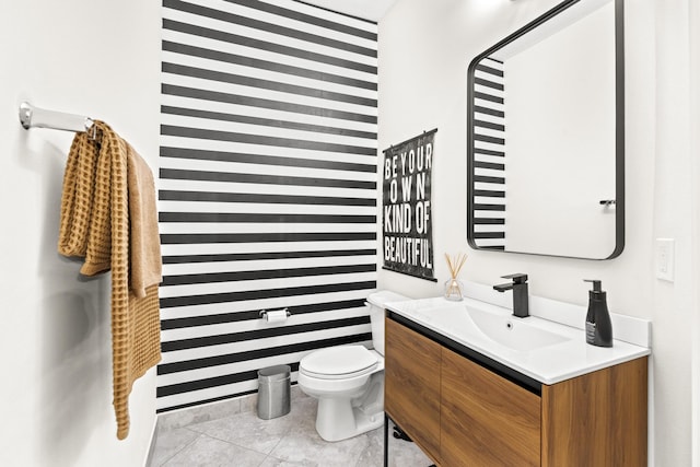 bathroom featuring tile patterned flooring, vanity, and toilet