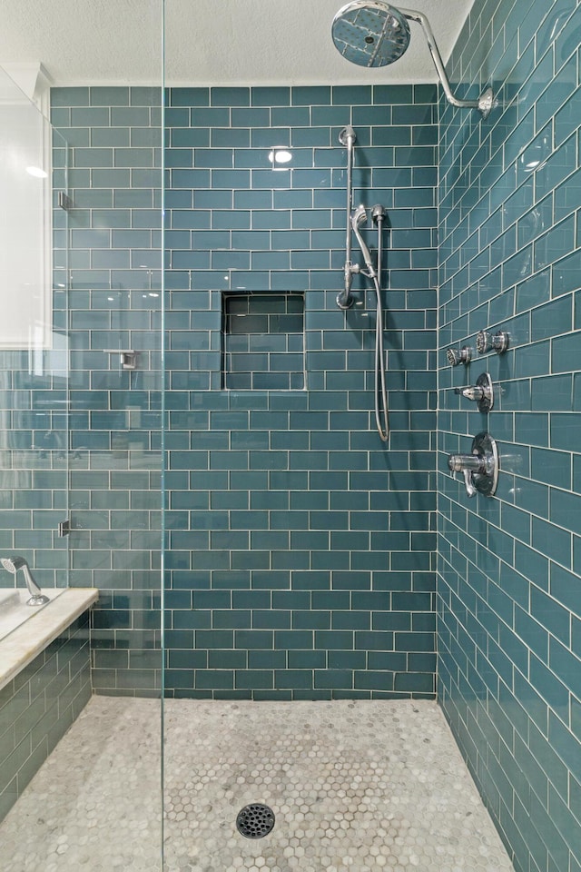 bathroom with tiled shower