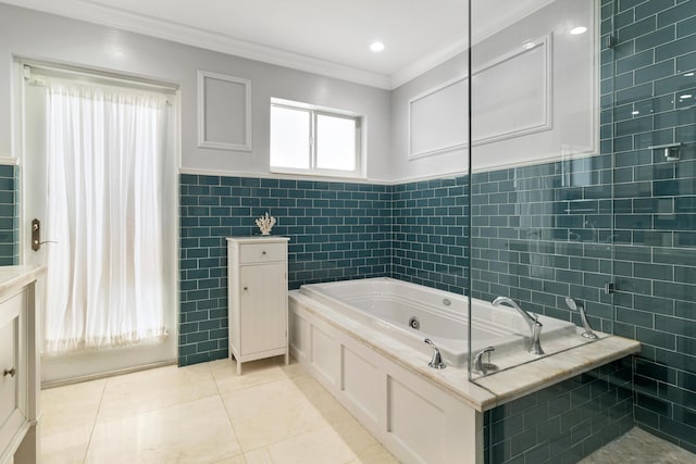 bathroom with tile patterned flooring, a bathing tub, tile walls, and crown molding