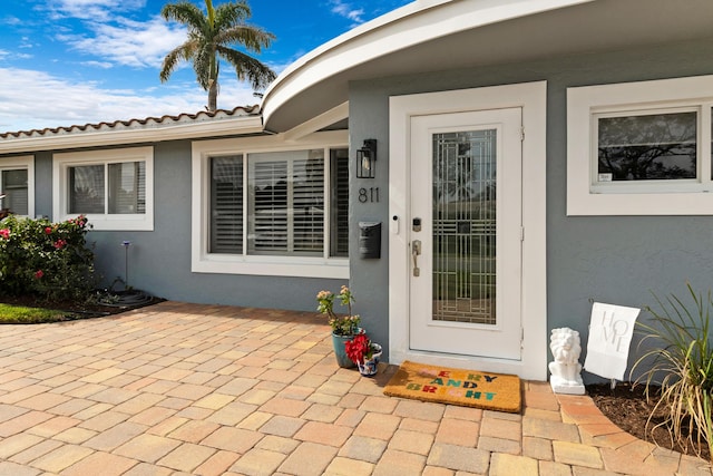 entrance to property featuring a patio area