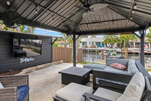 view of patio / terrace with a gazebo, an outdoor hangout area, ceiling fan, and a water view