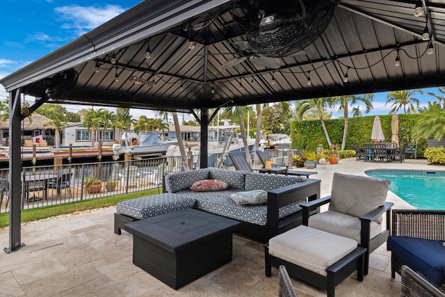 view of patio featuring a water view, a gazebo, and outdoor lounge area