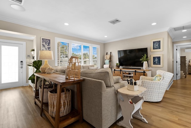 living room with crown molding, a wall mounted air conditioner, and hardwood / wood-style floors