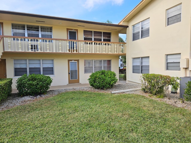 exterior space featuring central AC and a front yard