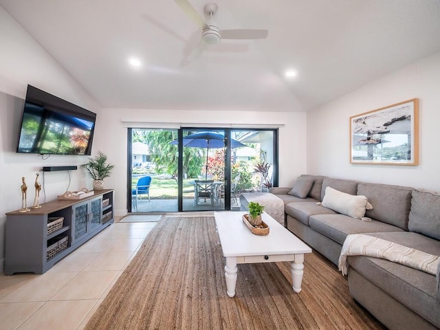 living room with ceiling fan, light tile patterned floors, and vaulted ceiling