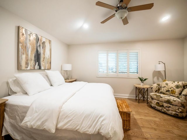 bedroom with ceiling fan and light hardwood / wood-style floors