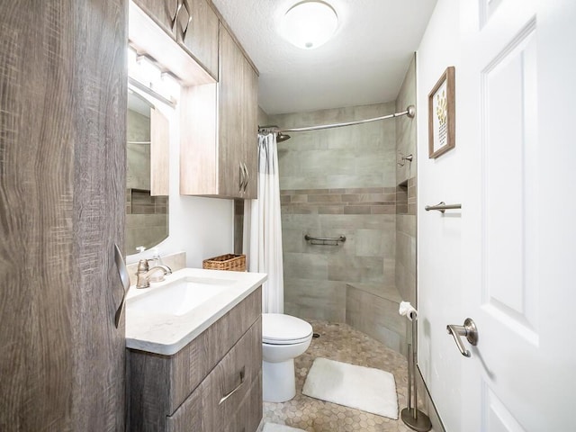 bathroom featuring a shower with curtain, vanity, toilet, and tile patterned floors