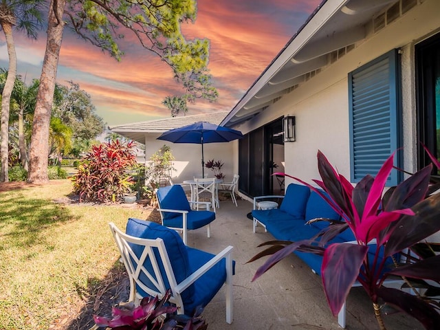 view of patio terrace at dusk