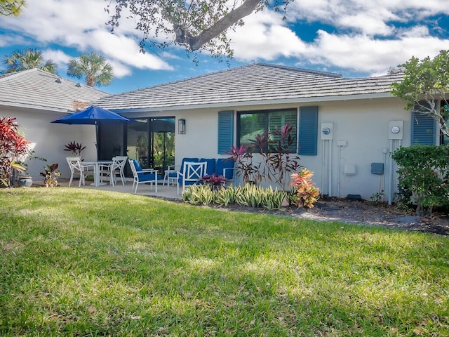 rear view of house with a patio area and a yard