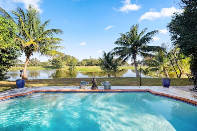 view of pool featuring a yard and a water view