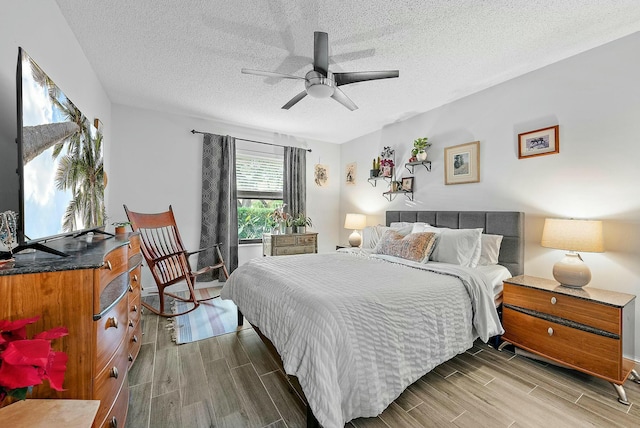 bedroom with hardwood / wood-style floors, a textured ceiling, and ceiling fan