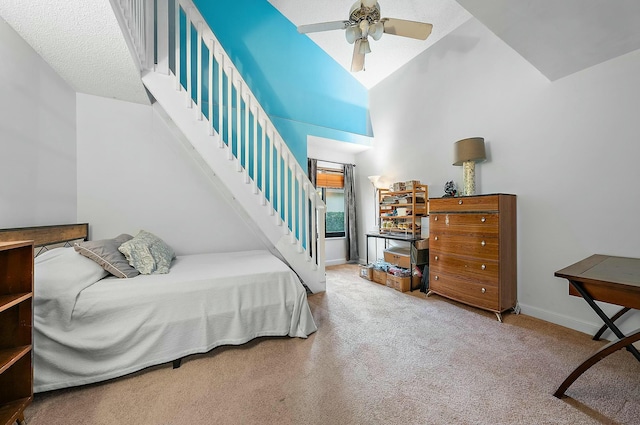 carpeted bedroom with a textured ceiling, high vaulted ceiling, and ceiling fan