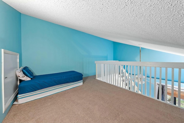 carpeted bedroom with a water view and a textured ceiling