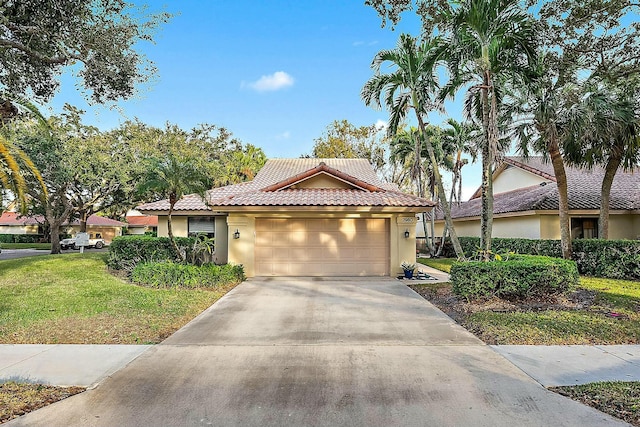 view of front of property featuring a garage and a front lawn