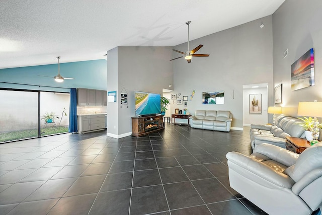 tiled living room with ceiling fan, high vaulted ceiling, and a textured ceiling