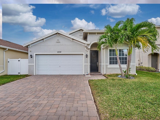 view of front of home with a front lawn and a garage