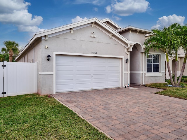 view of front of property featuring a front lawn and a garage