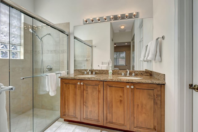 bathroom featuring vanity and a shower with door