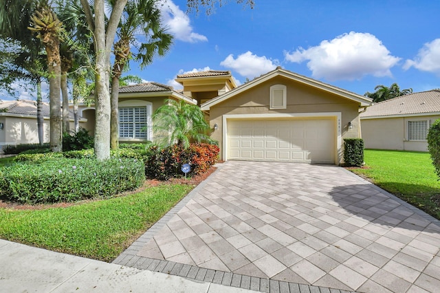 view of front facade with a garage and a front yard