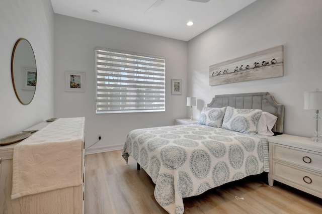 bedroom with ceiling fan and light wood-type flooring