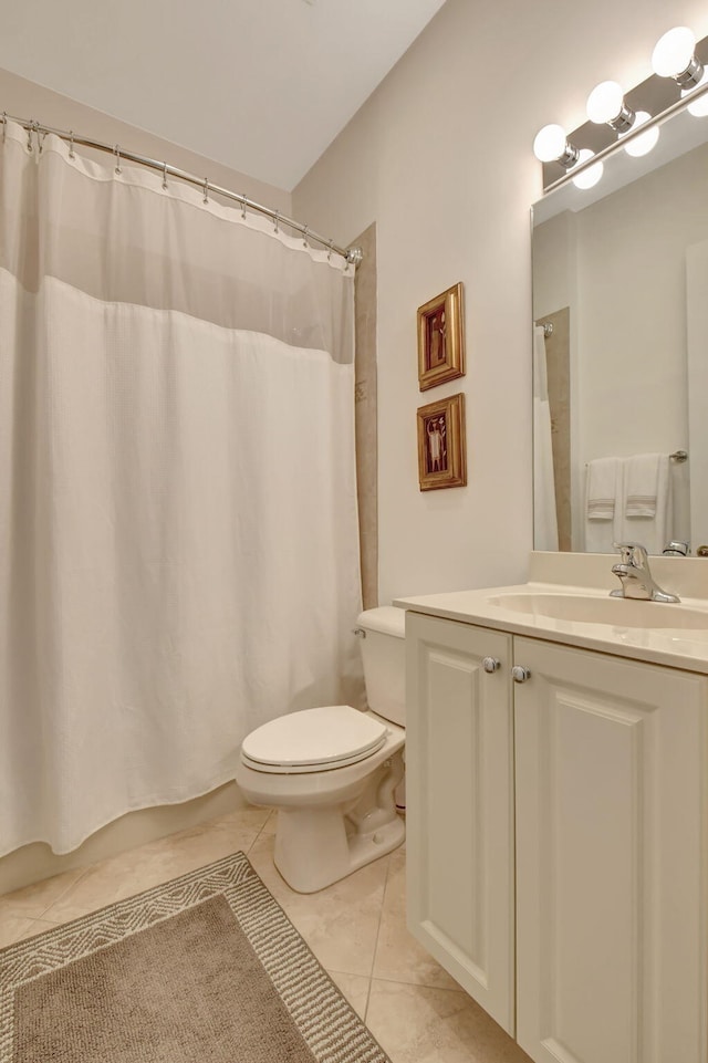 bathroom with tile patterned flooring, vanity, and toilet