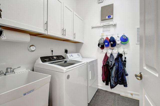 laundry area featuring cabinets, independent washer and dryer, and sink