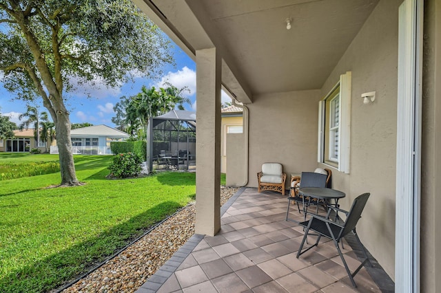 view of patio / terrace featuring glass enclosure