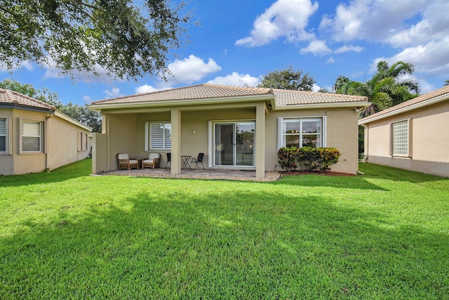 back of house featuring a yard and a patio