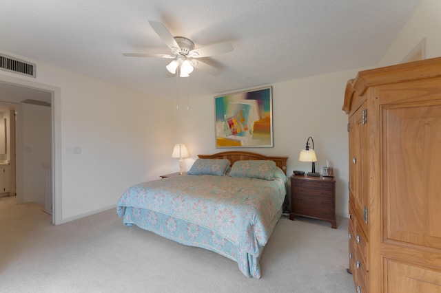 carpeted bedroom featuring a textured ceiling and ceiling fan