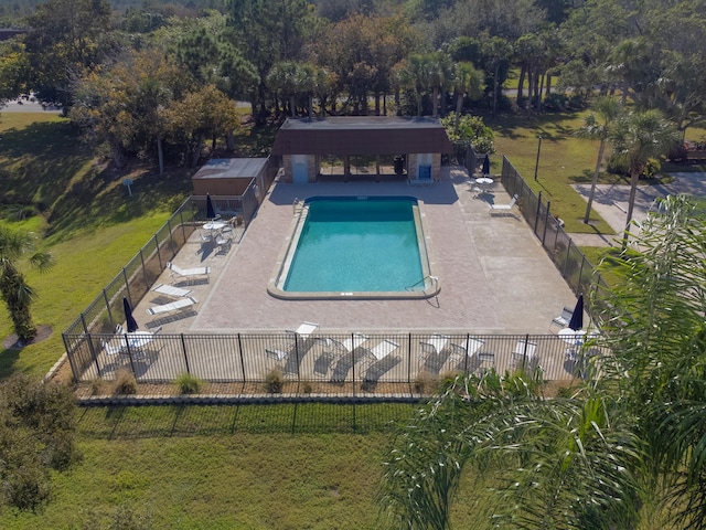 view of pool featuring a yard and a patio